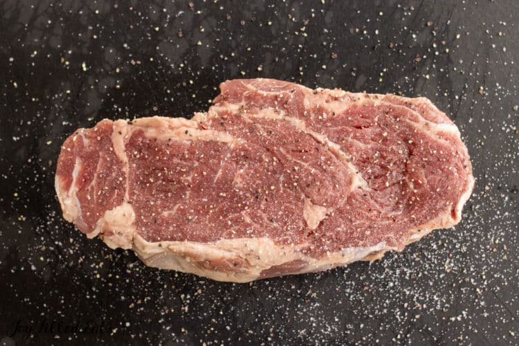 seasoned steak on cutting board
