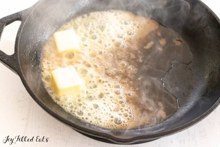 cast iron skillet with simmering butter