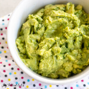 4 ingredient guacamole recipe in bowl on polka dot napkin close up