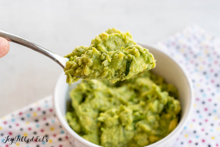 spoon lifting up some guac