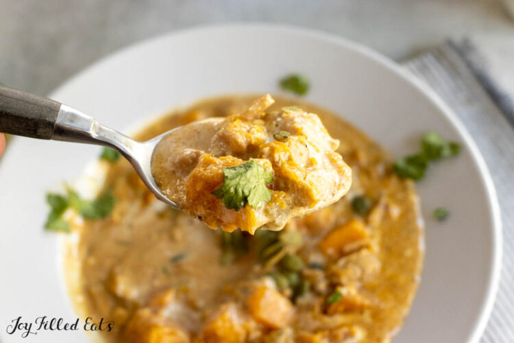 autumn chili recipe lifted up on soup spoon