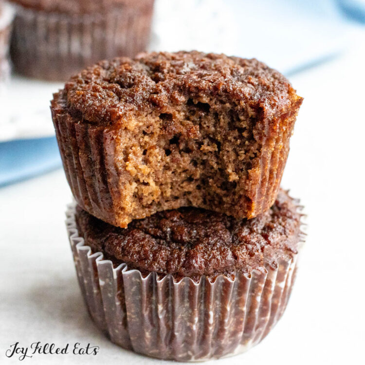 chocolate protein muffins with top muffin missing a bite and napkin behind