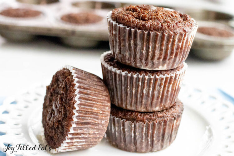 chocolate protein muffins stacked 3 high with one on its side