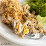 chicken leek mushroom casserole recipe on dinner plate with bite on fork close up