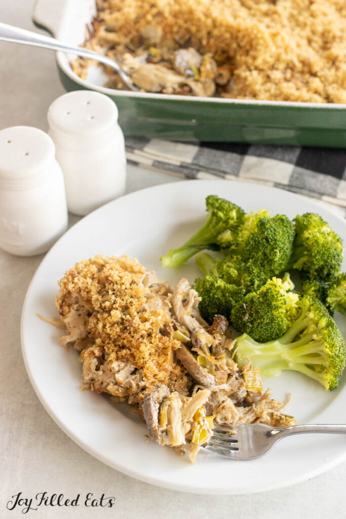 bite of chicken leek mushroom casserole on a fork on dinner plate