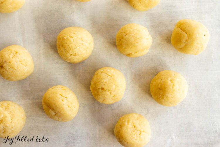 rolled balls of filling on parchment
