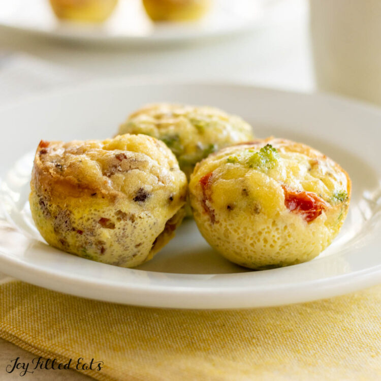 dairy free egg bites on small plate with coffee behind