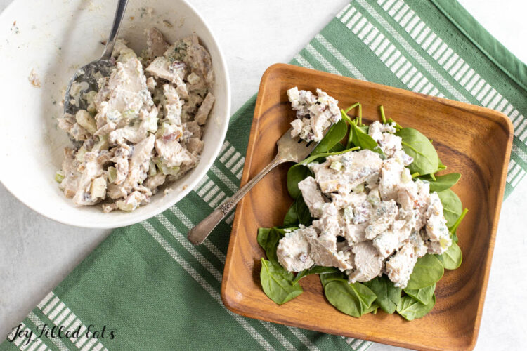 blue cheese chicken salad in serving bowl and on lunch plate with spinach