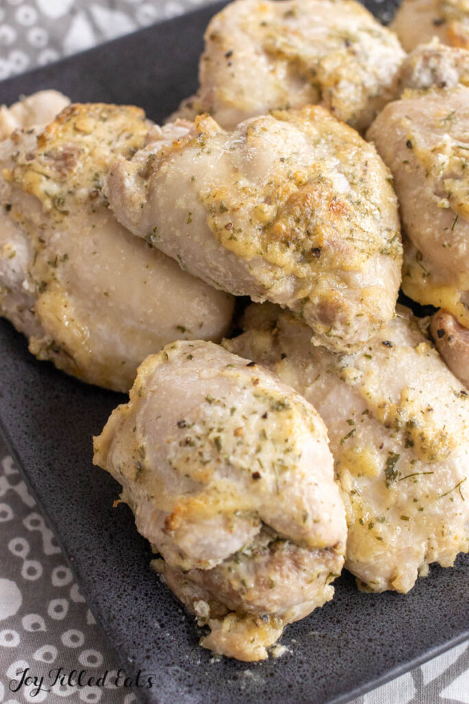 black serving platter with boneless chicken thighs