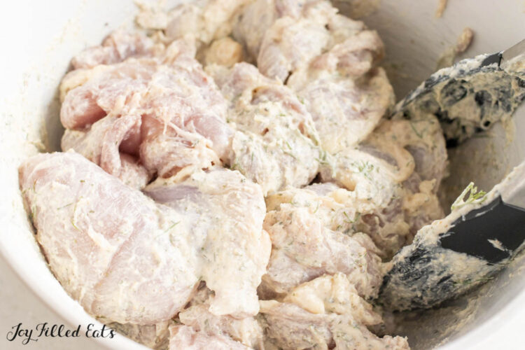 pieces of chicken in mixing bowl