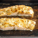 baked salmon with mayonnaise close up on stoneware baking dish