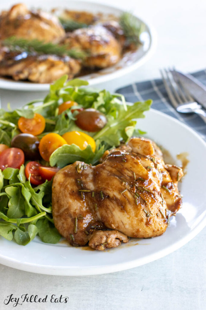 dinner plate with salad and rosemary balsamic chicken thighs