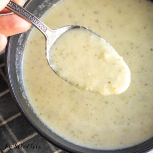 cauliflower leek soup recipe on spoon being held up