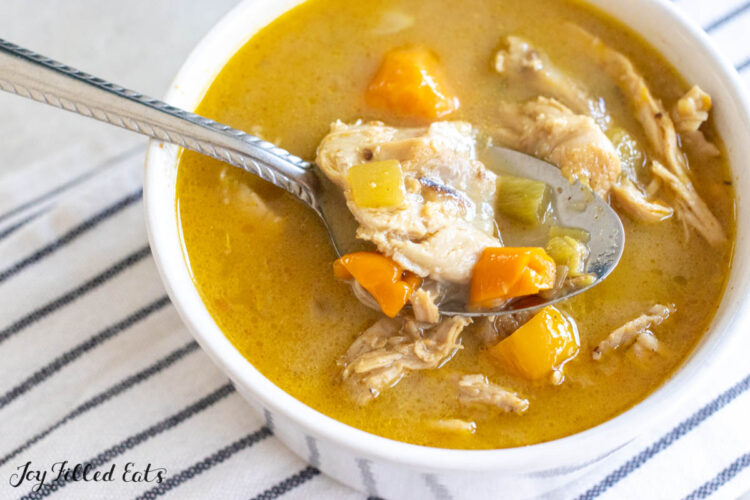 dairy free creamy chicken soup in bowl with spoon