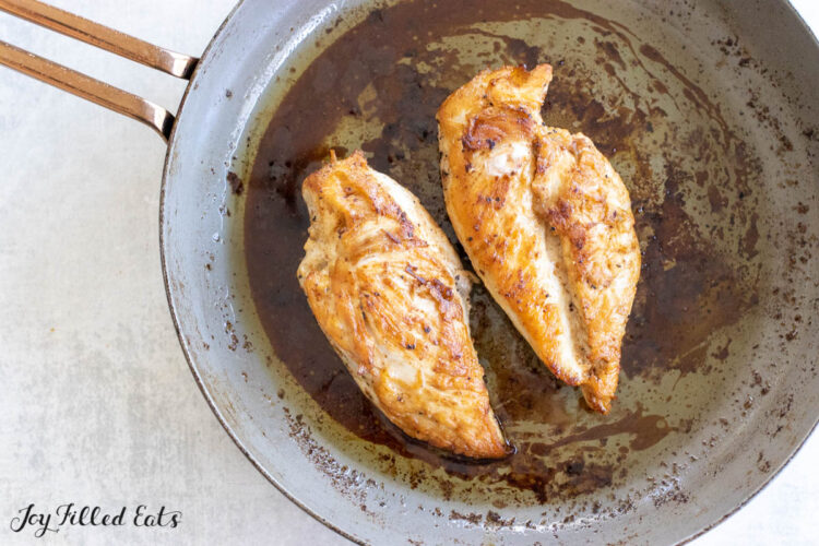 butter poached chicken in a frying pan