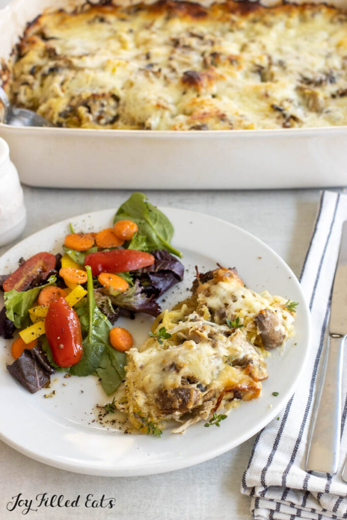 chicken tetrazzini casserole on dinner plate with salad