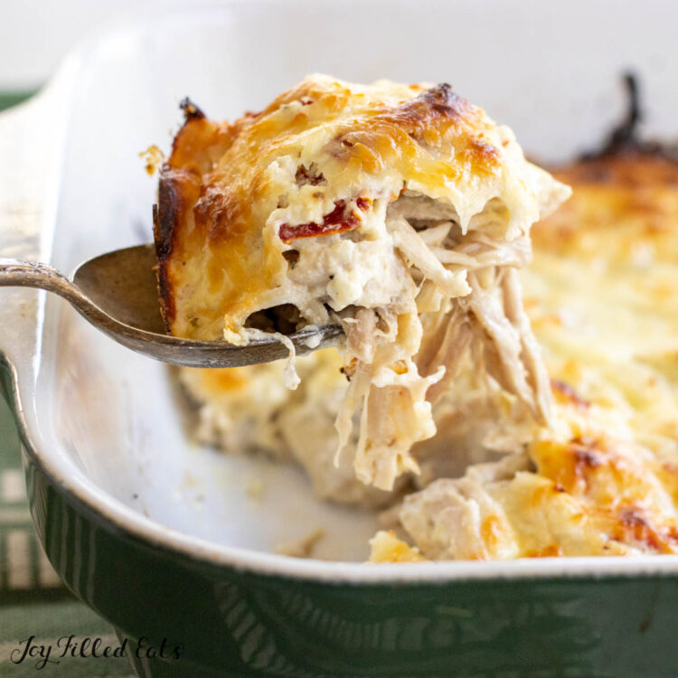 marry me chicken casserole being lifted by serving spoon close up