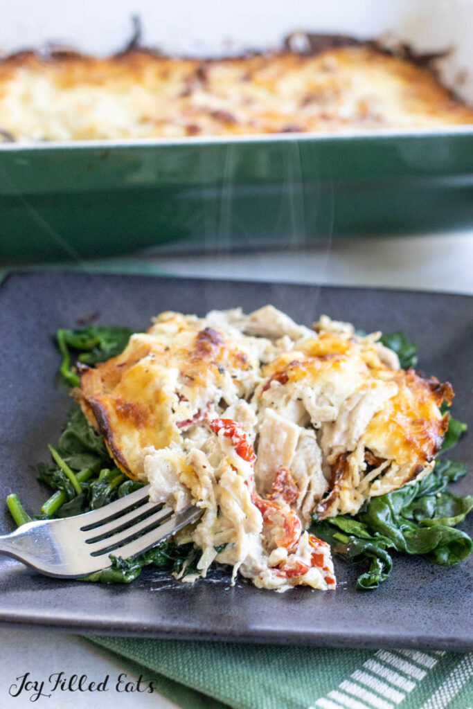 bite of marry me chicken casserole on a fork with steam coming up