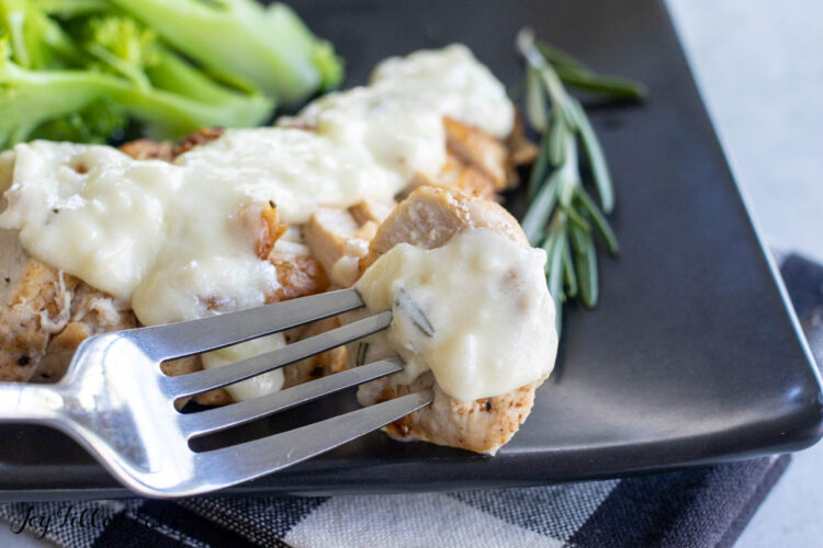 bite of chicken with sauce on fork