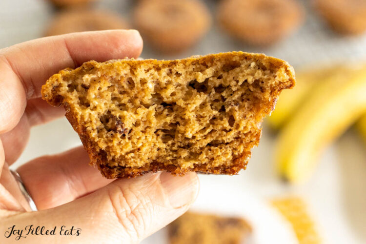 hand holding up one of the banana bread muffins with almond flour