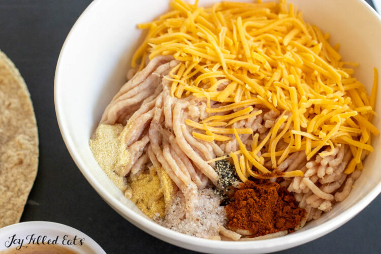 meat, cheese, and seasonings in bowl