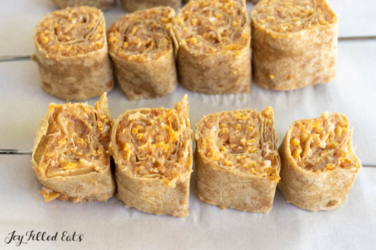 skewers with pinwheels on baking sheet lined with parchment close up