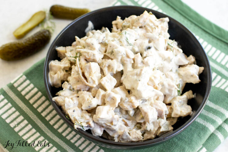 dill pickle chicken salad in a bowl on a green towel