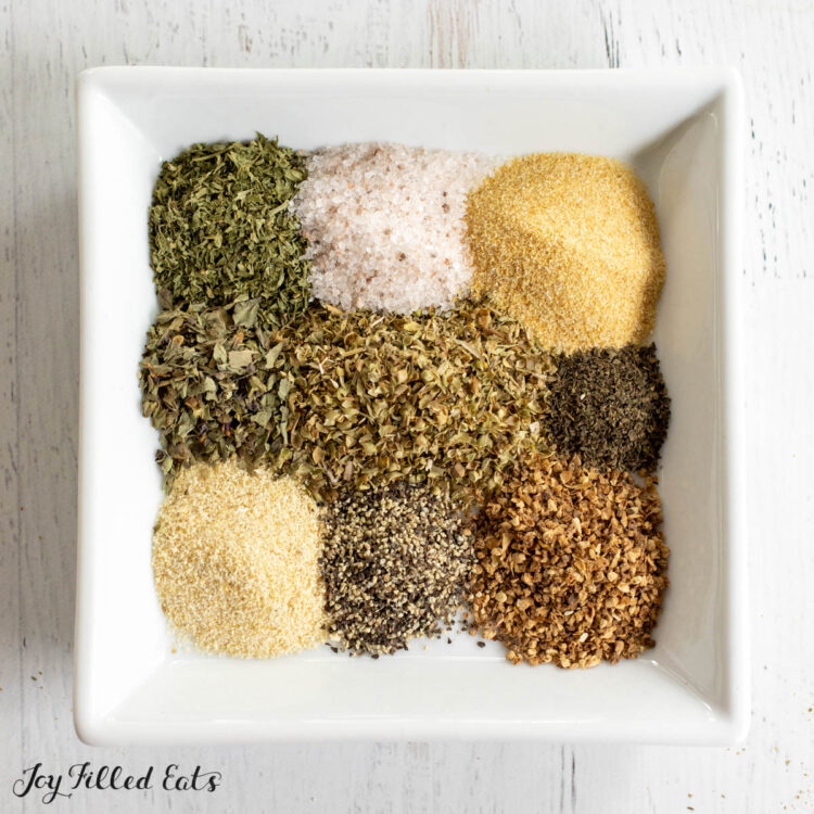 greek seasoning recipe on white plate from overhead showing individual spices
