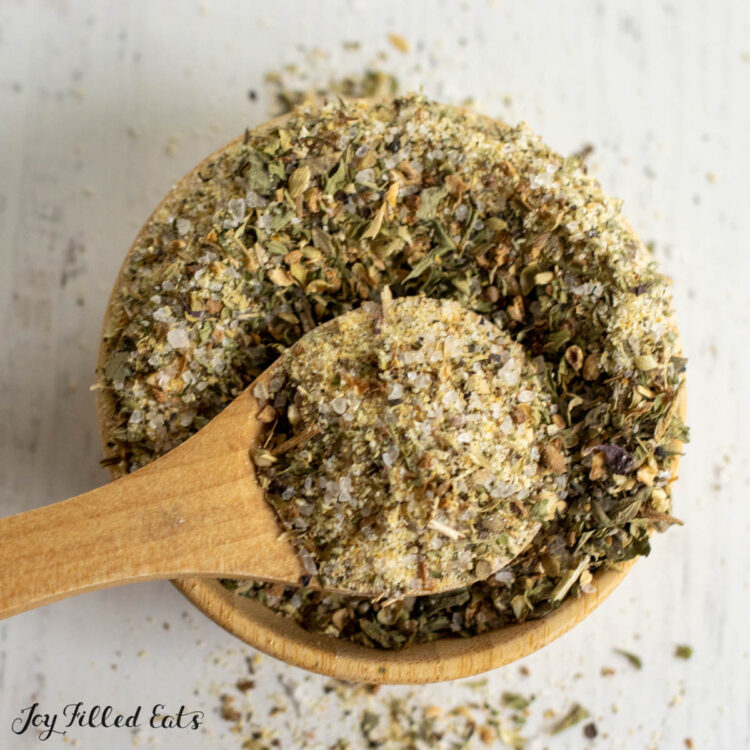 small wooden spoon in greek seasoning close up