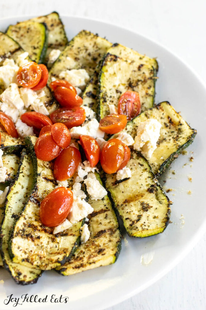 grilled greek zucchini vertical shot on a serving platter