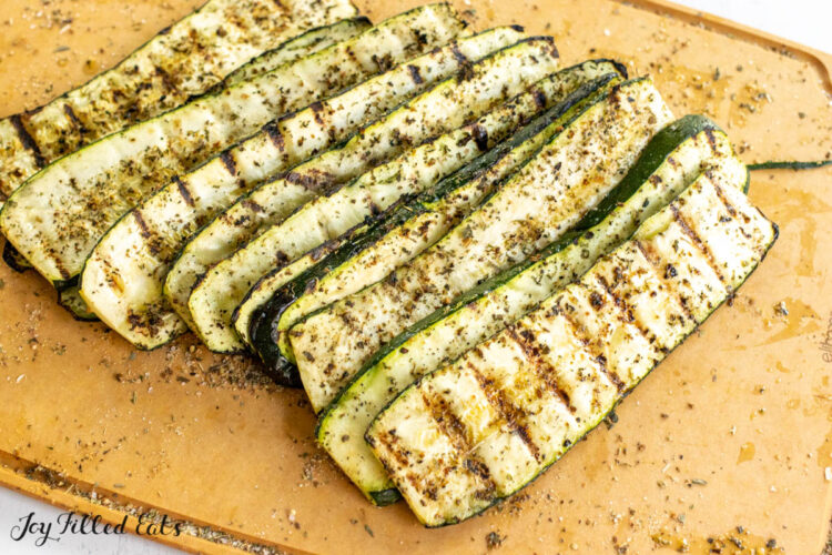 greek seasoning on grilled zucchini on cutting board