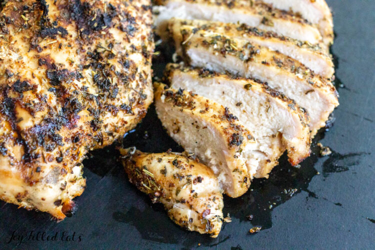 sliced tuscan chicken on cutting board