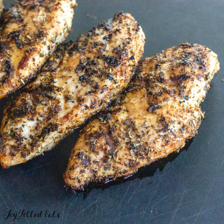 tuscan grilled chicken resting on cutting board