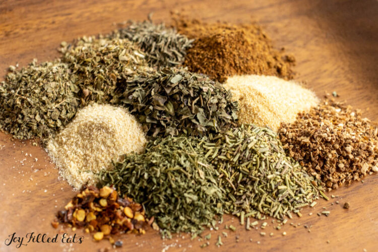 small piles of spices and herbs on plate
