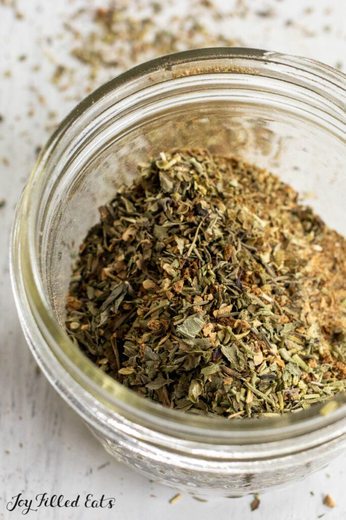 tuscan seasoning recipe in glass jar from overhead close up vertical