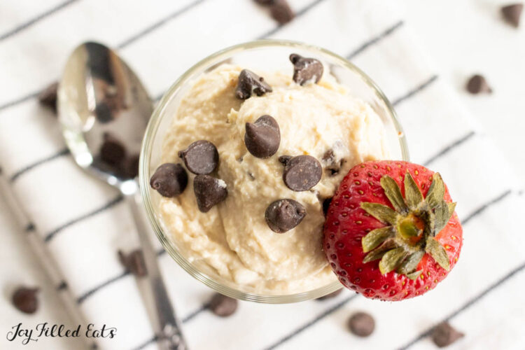 cottage cheese cookie dough in a small glass from overhead  topped with chocolate chips and strawberry