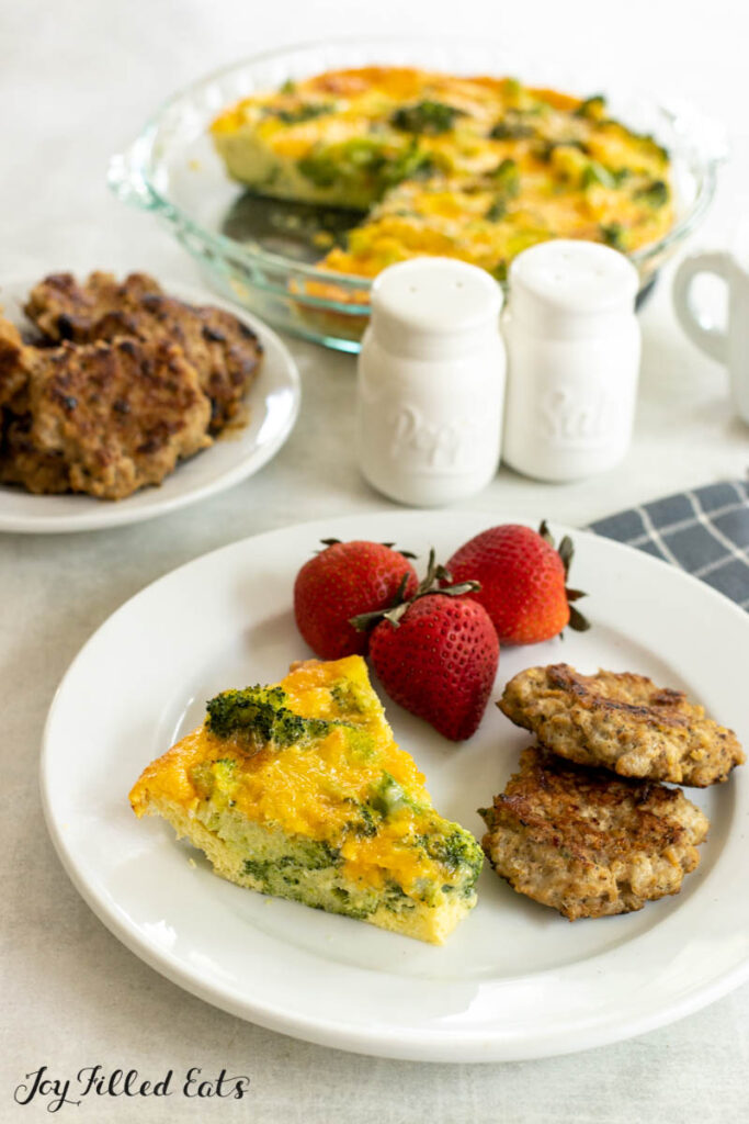 slice of broccoli quiche on a breakfast plate with rest behind