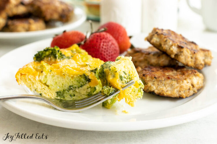 bite of broccoli quiche on a fork on breakfast plate