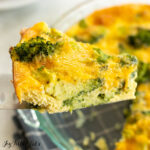 broccoli quiche recipe slice being held up by a serving spatula