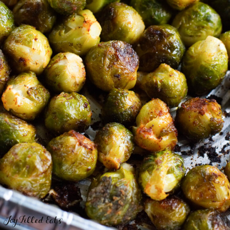 grilled brussels sprouts in an aluminum foil pan