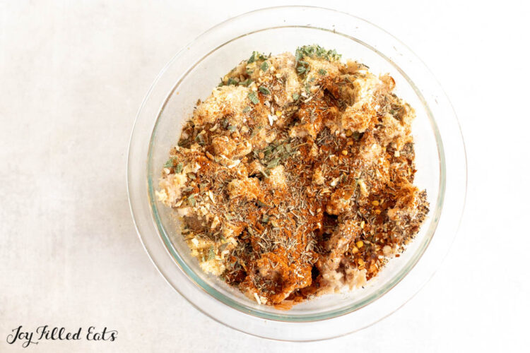 breakfast sausage seasoning on raw meat in bowl
