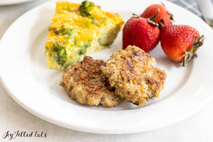 sage seasoned breakfast sausage on plate with quiche and berries