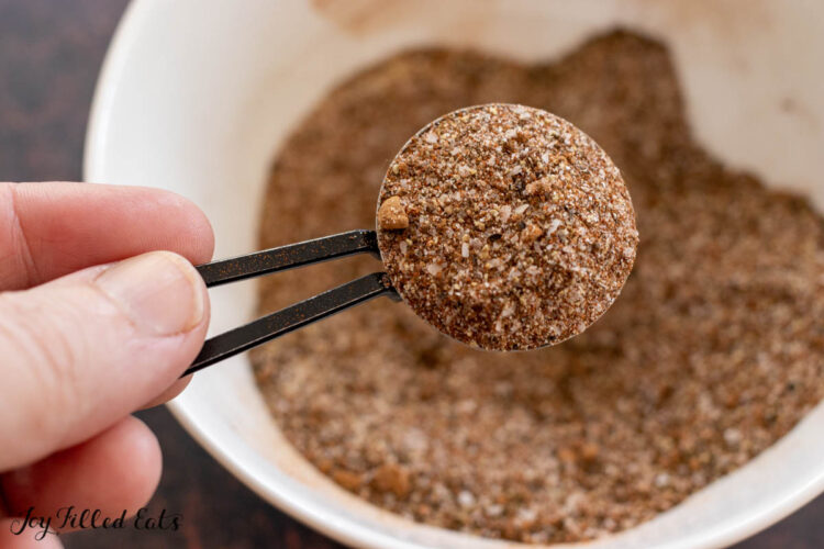 coffee rub being held up in measuring spoon