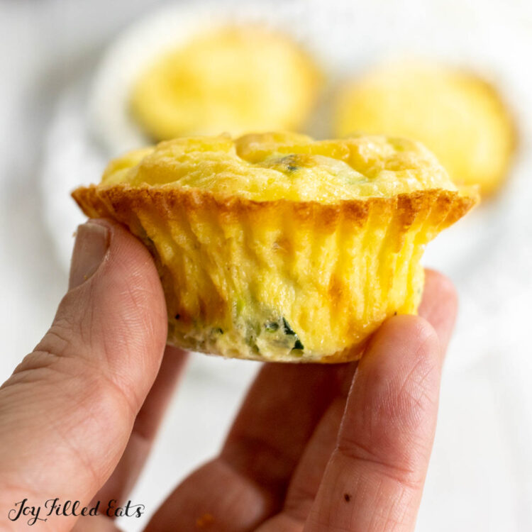 hand holding up one of the egg zucchini muffins