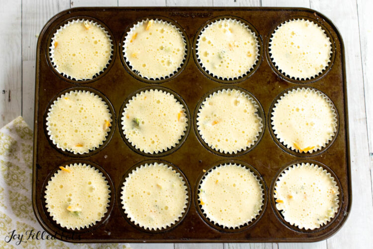 egg mixture added on to muffin cups
