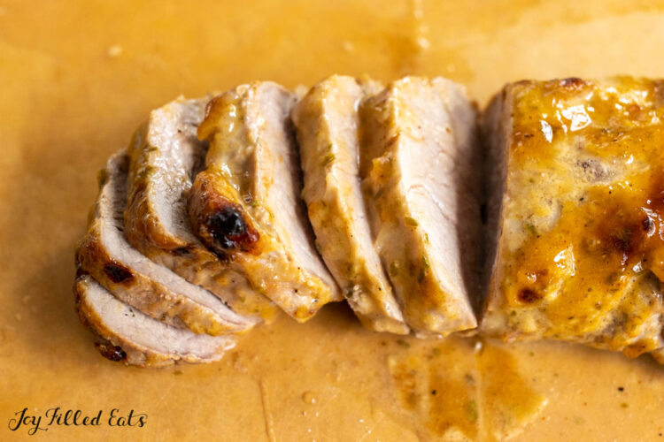 sliced pork tenderloin on a cutting board