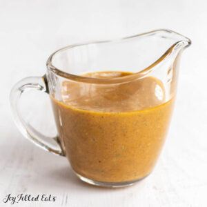 honey mustard sauce in small glass pitcher close up