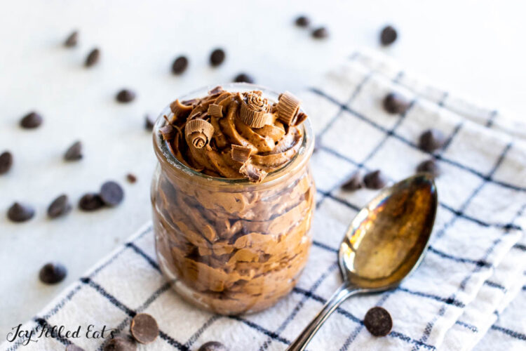jar of chocolate mousse on plaid napkin with spoon