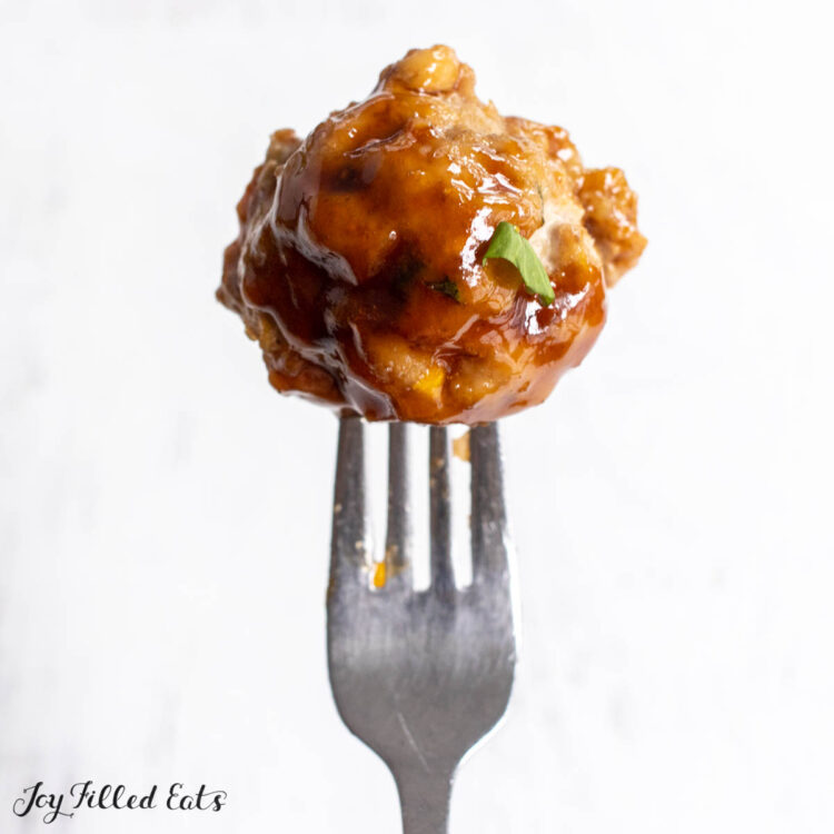 fork holding up thai pork meatballs