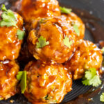 thai pork meatballs close up on black plate